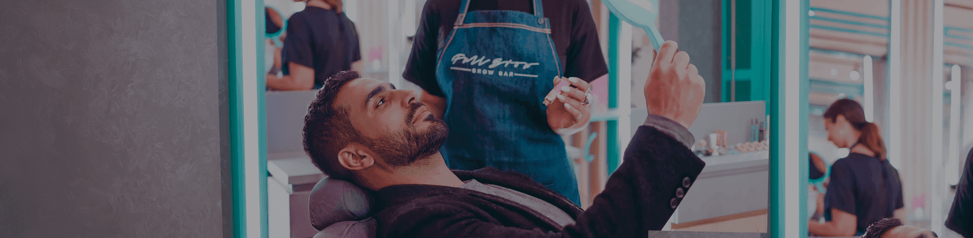 Male customer receiving brow grooming service in a Full Brow Bar studio